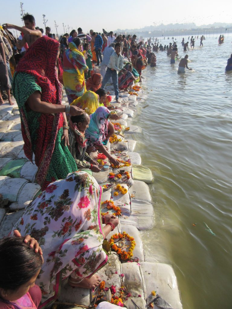 Indians performing poojahs in the Sangam before dipping in the river.