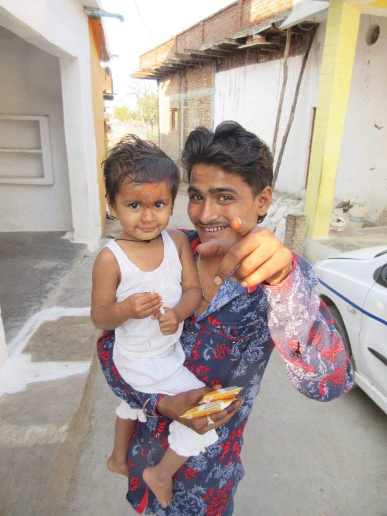 Kuldeep with his daughter, Pari. Pari has the turmeric coloring on her forehead for protection. 