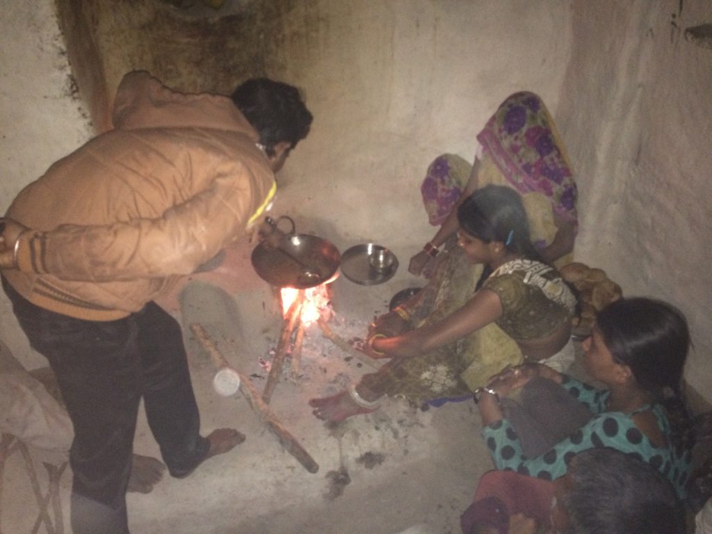 Cooking under natural fire with the village family.