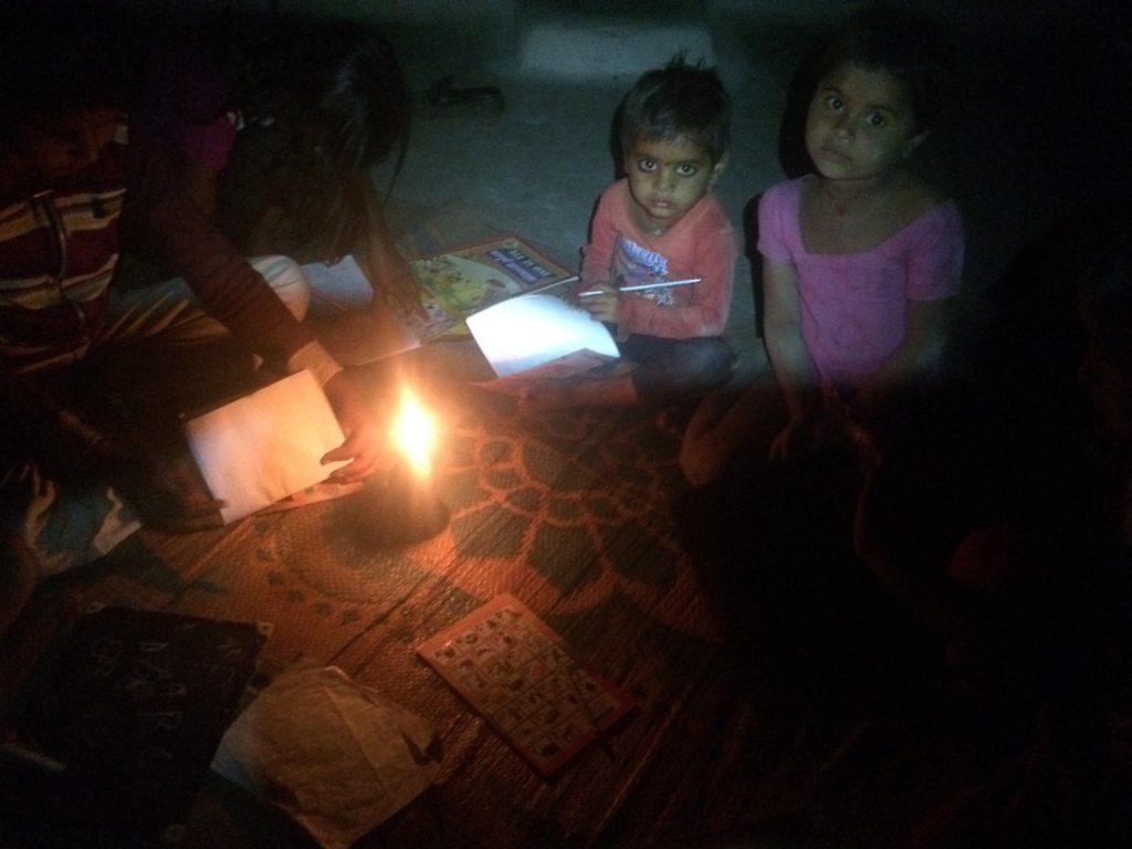 Giving English lessons under candle light, as the village doesn’t have electricity.