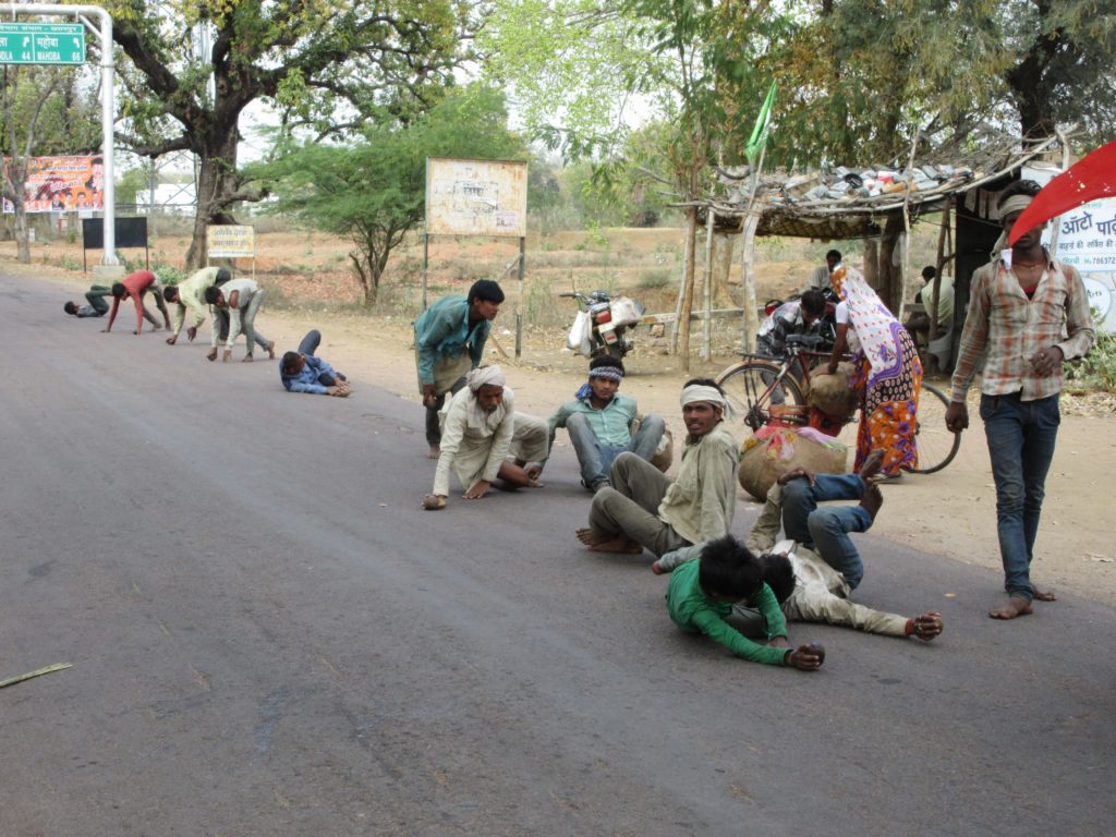 Hindu men rolling along the streets for days to arrive at the temples in Khajuraho for Shivaratri.