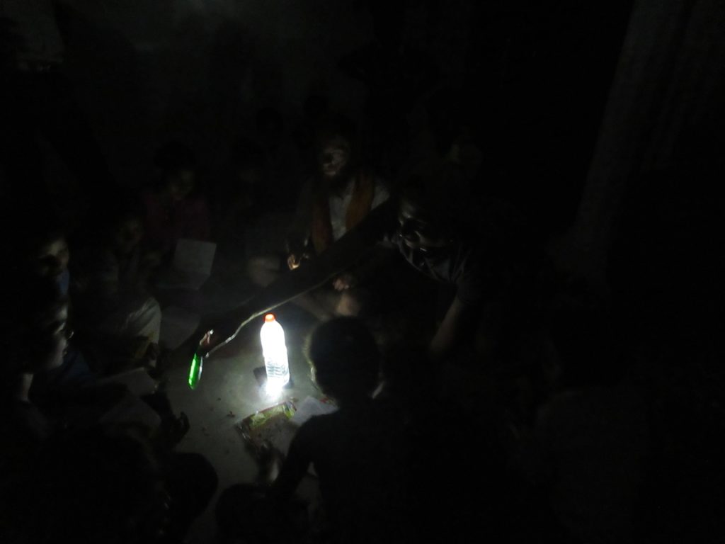 English lessons village using my make-shift lantern, a water bottle with my headlamp attached, as there's no electricity in the village. 