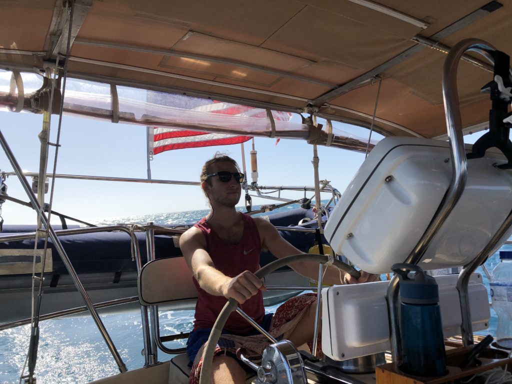 In my element, steering the boat at the helm
